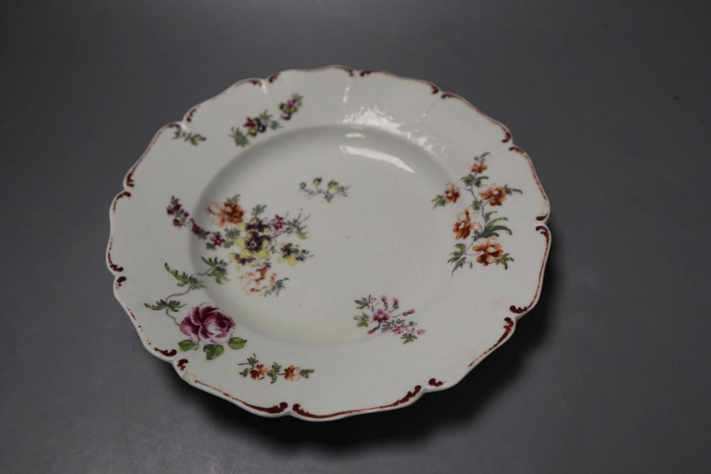 A Derby asymmetric vase moulded with rococo scrolls and painted with flower and a Derby plate painted with flower,